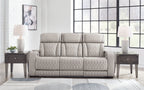 Gray 3-seat reclining sofa with quilted upholstery and three padded headrests