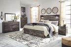 Panel bed with four side drawers, dark distressed wood, upholstered pillows and blanket