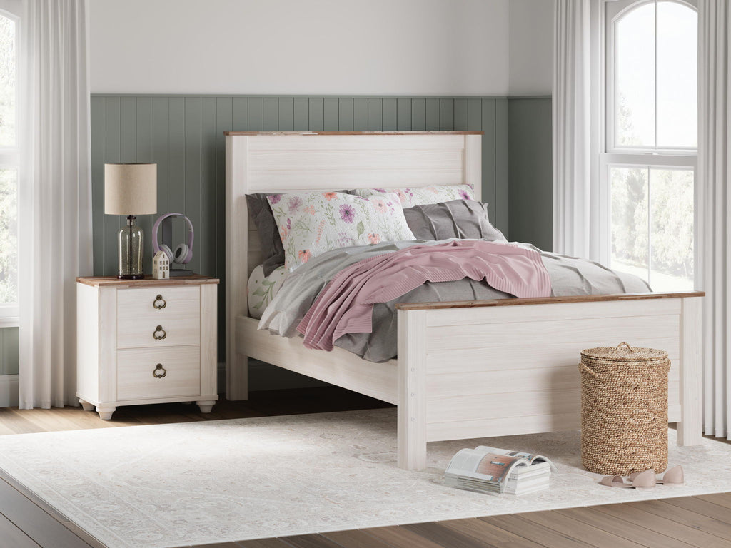 Beige panel bed with two drawers and slatted headboard, styled with mixed-color quilts
