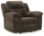 Chocolate fabric rocker recliner chair with padded arms and tufted backrest