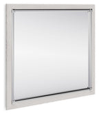 Rectangular bedroom mirror with light wood frame and clear glass