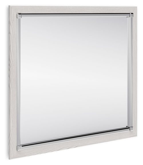 Rectangular bedroom mirror with light wood frame and clear glass
