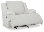 White rocker recliner chair with ribbed seat, reclined back, and footrest