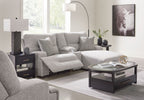 Light gray sectional sofa with raf chaise and patterned accent pillows, reclined seat