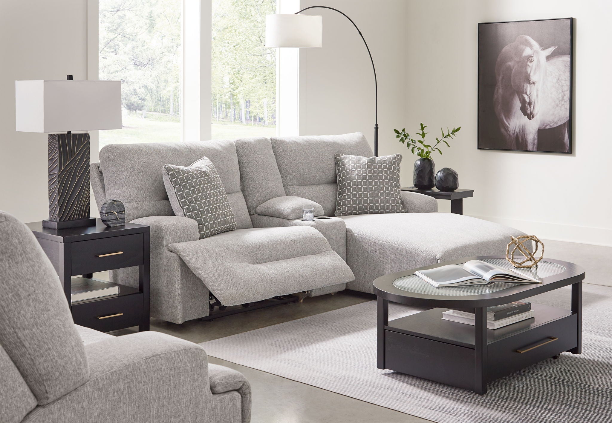 Light gray sectional sofa with raf chaise and patterned accent pillows, reclined seat