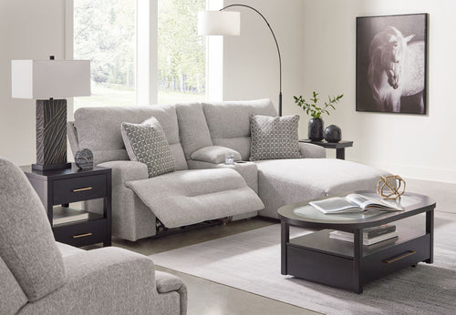 Light gray sectional sofa with raf chaise and patterned accent pillows, reclined seat
