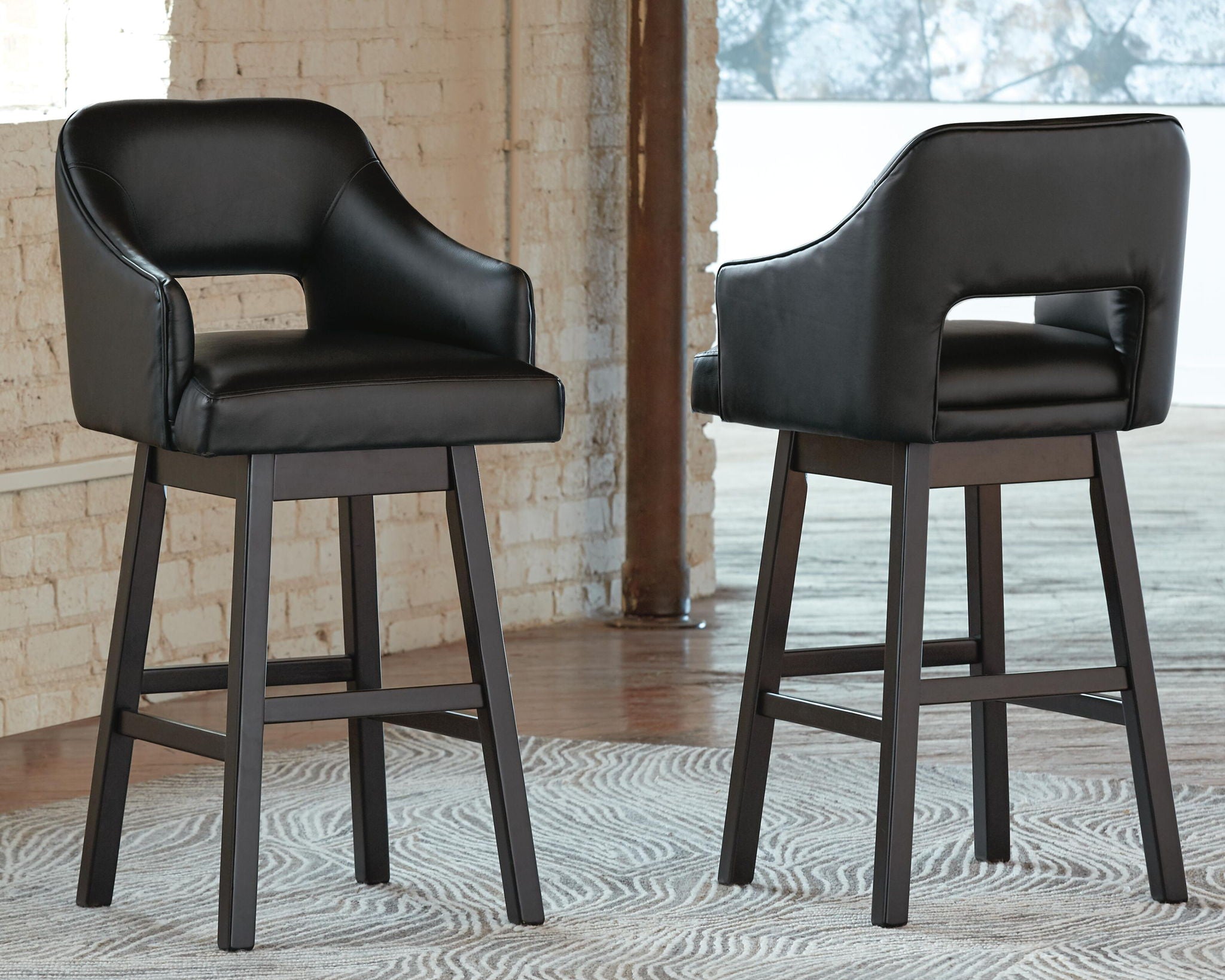 Black upholstered barstools with padded seat, curved back, and footrest rails, set of 2