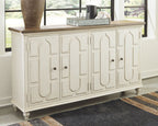 Antique white accent cabinet with carved doors, dark pulls, and wood top
