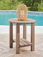Light brown oval side table with slatted tabletop, built-in lower shelf, four legs