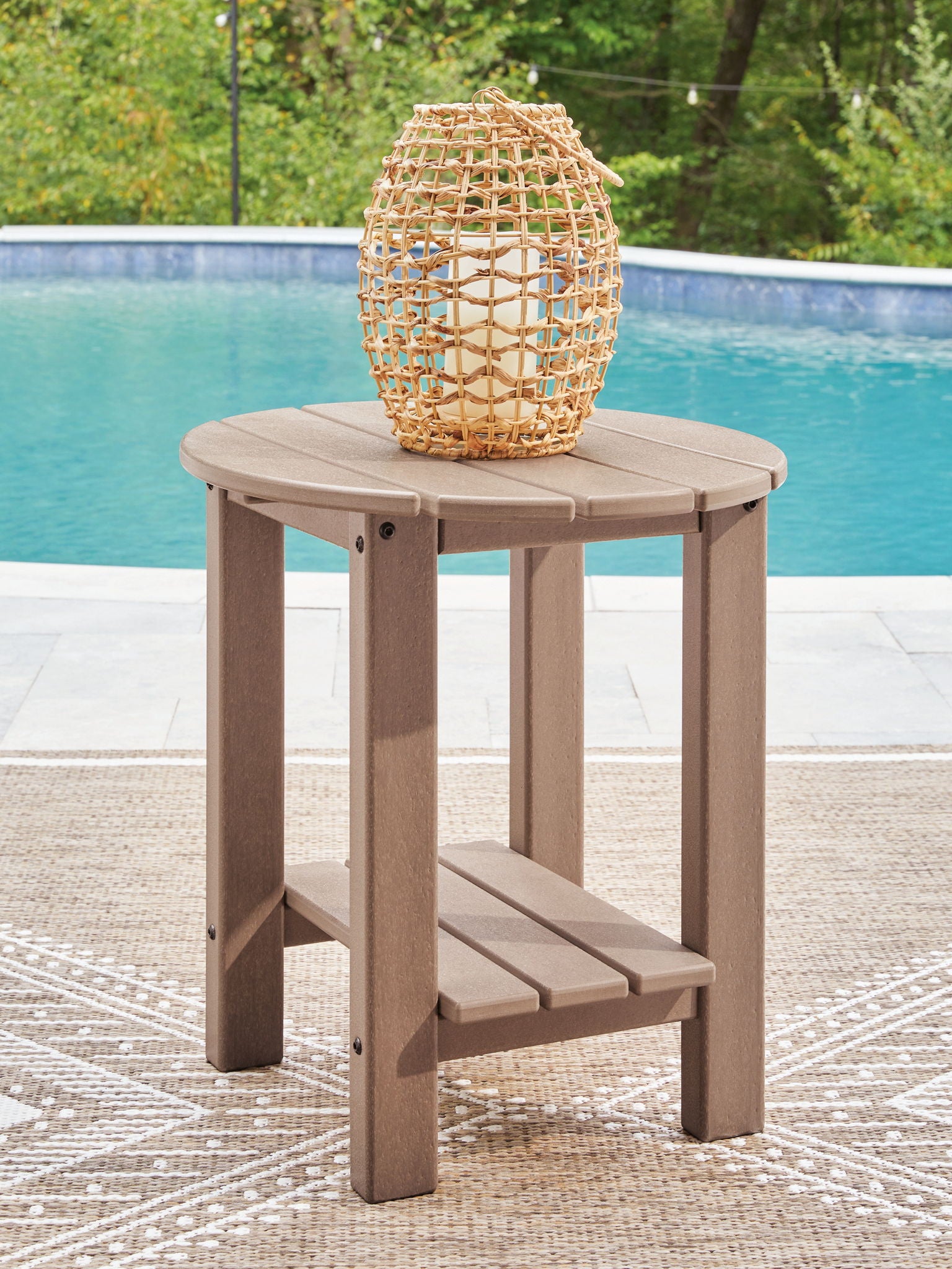 Light brown oval side table with slatted tabletop, built-in lower shelf, four legs