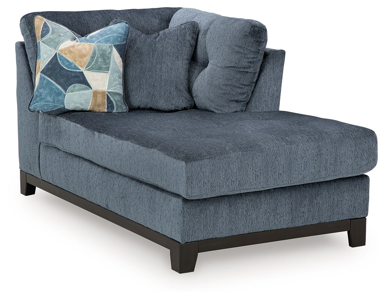 Navy corner chaise with tufted seat, rolled backrest, and geometric pillow
