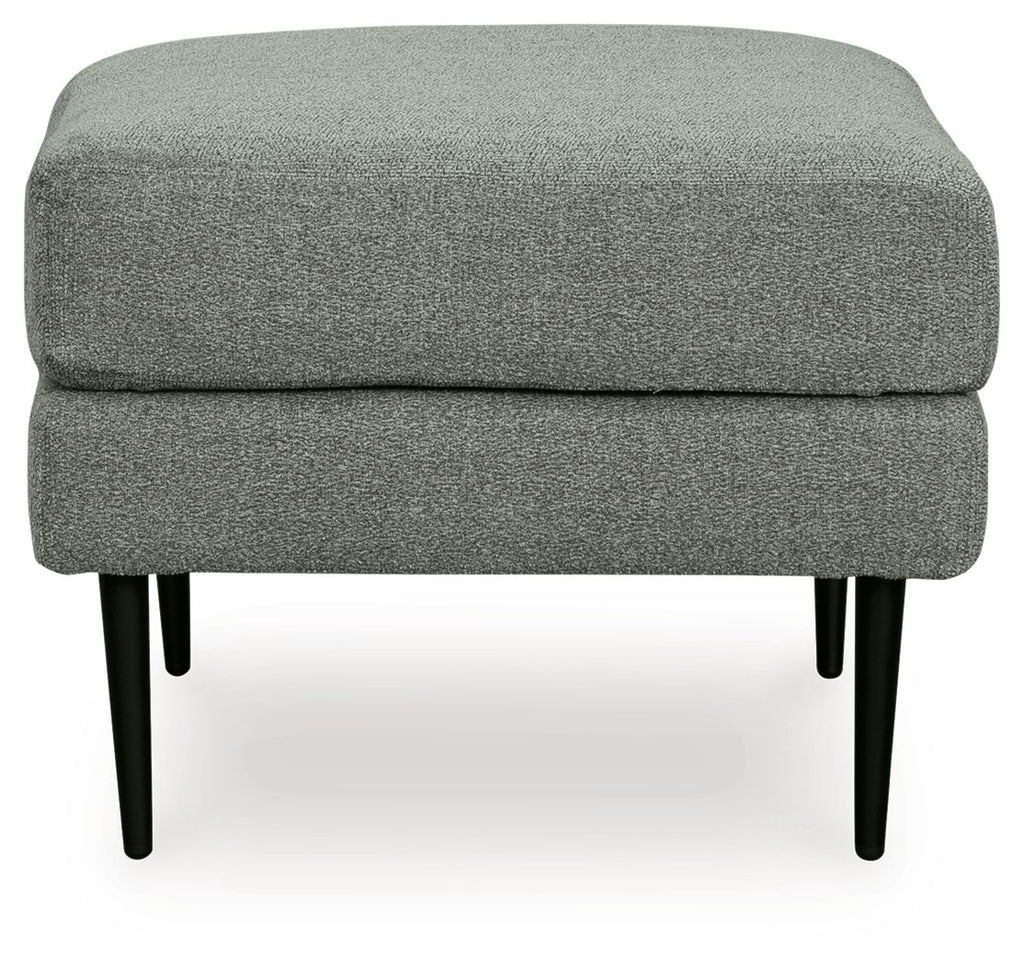 Charcoal upholstered ottoman with plush top cushion and tapered black legs