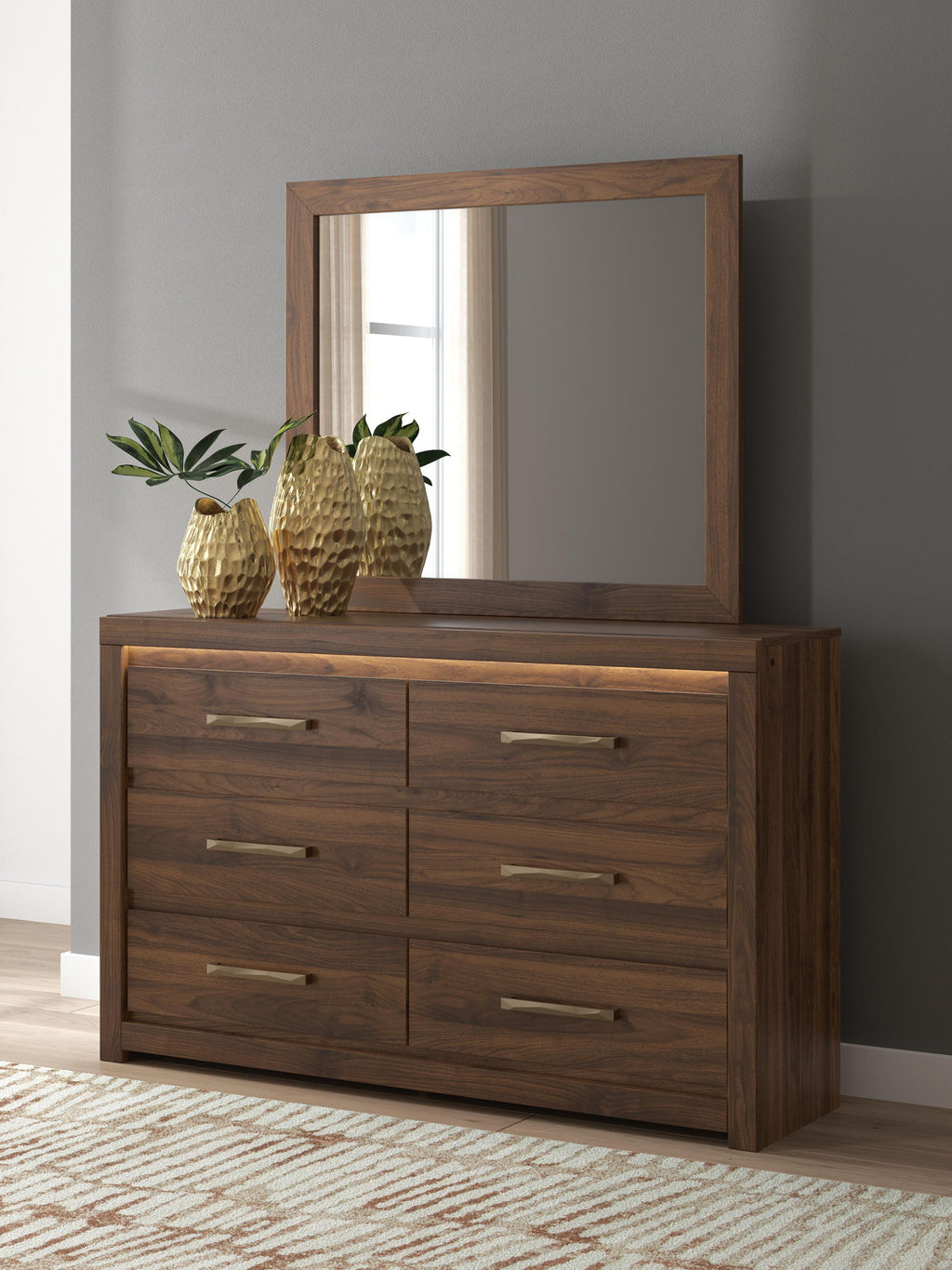 Light brown dresser with square mirror and six drawers with bar pulls.
