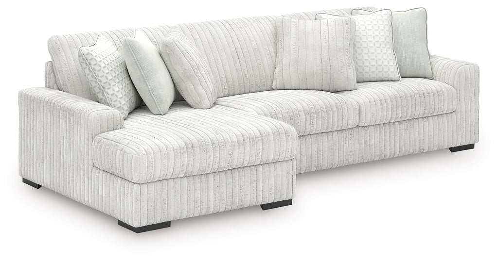 Off-white striped sectional sofa with chaise seating and square back pillows.