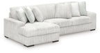 Off-white striped sectional sofa with chaise seating and square back pillows.