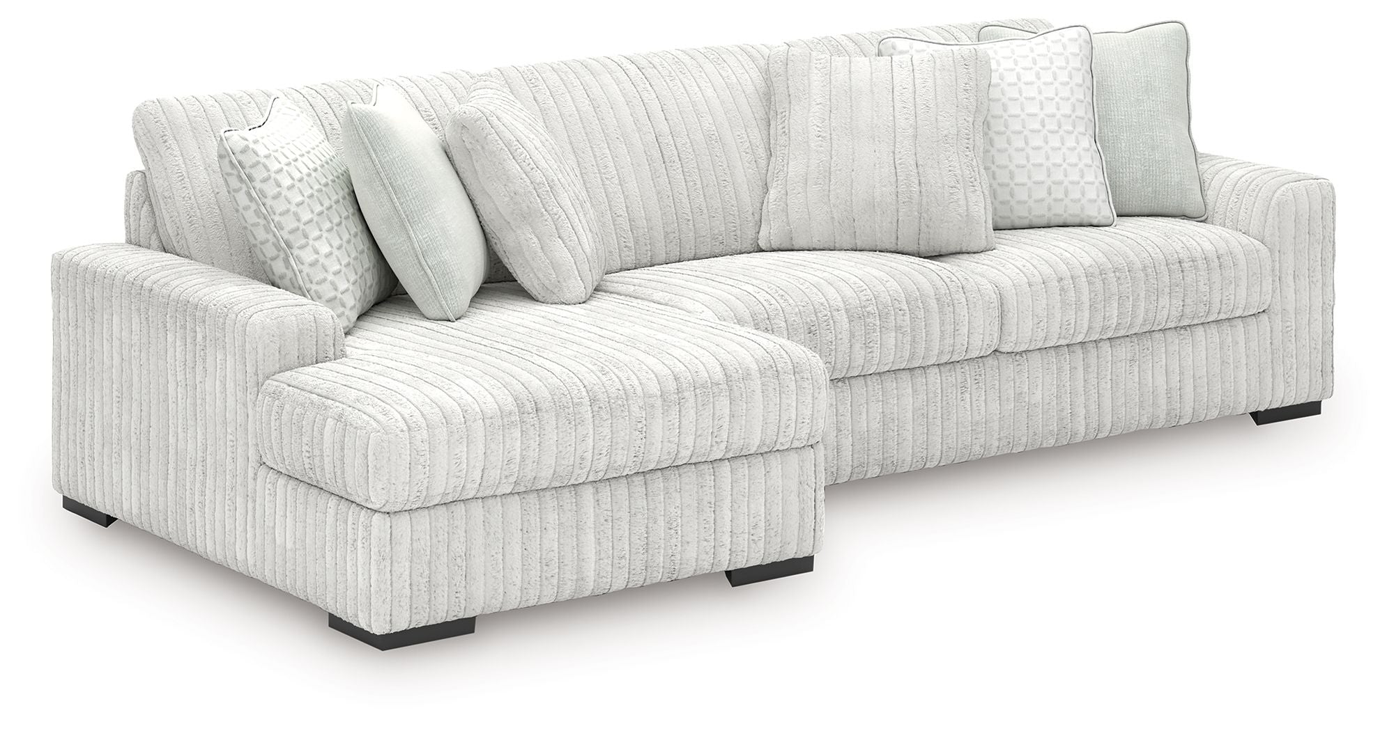 Off-white striped sectional sofa with chaise seating and square back pillows.