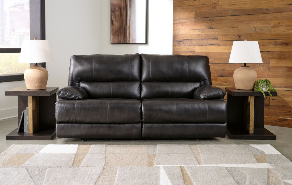Black leather-look sofa with tufted back cushions and padded seating