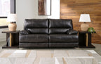 Black leather-look sofa with tufted back cushions and padded seating