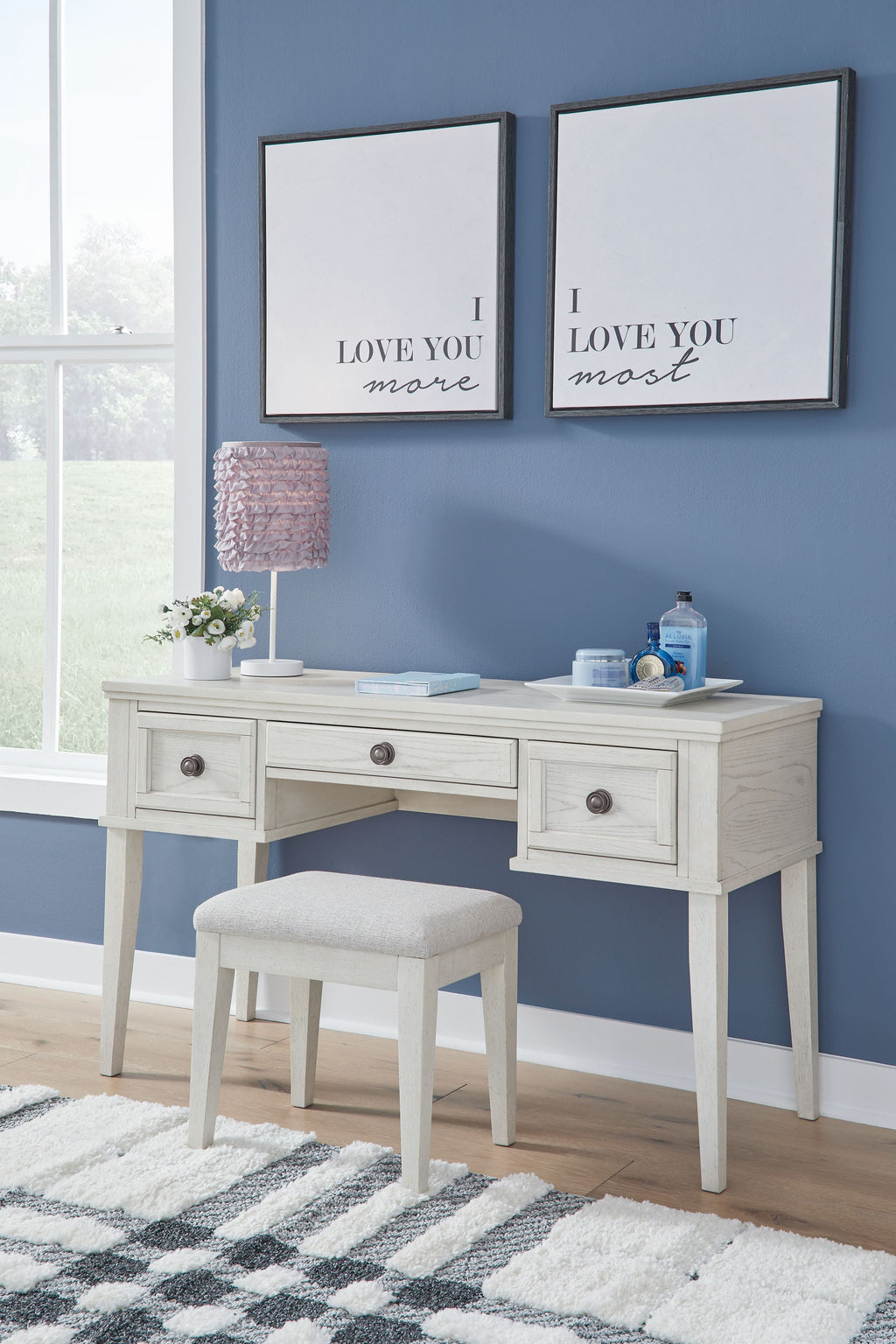 Antique white vanity table with open drawers and matching stool, set with two wall mirrors.
