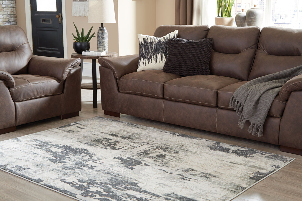 Gray distressed abstract area rug displayed on a floor in a living room