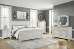 White panel bedroom set with bed, dresser, and mirror