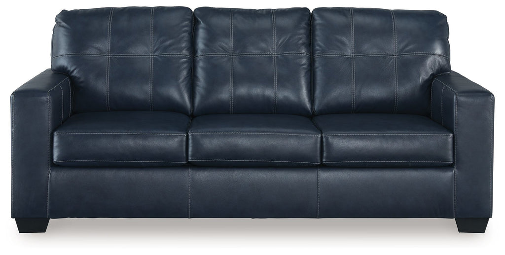 Navy blue sofa sleeper with padded arms and tufted back cushions