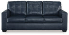 Navy blue sofa sleeper with padded arms and tufted back cushions