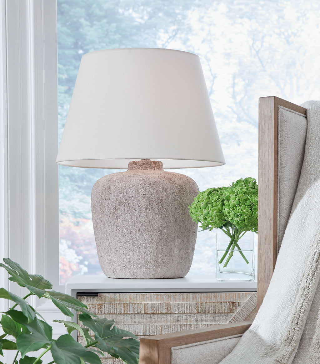 Metal table lamp with white drum shade and textured gray round base
