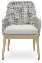 Gray woven armchair with white seat cushion and wide backrest