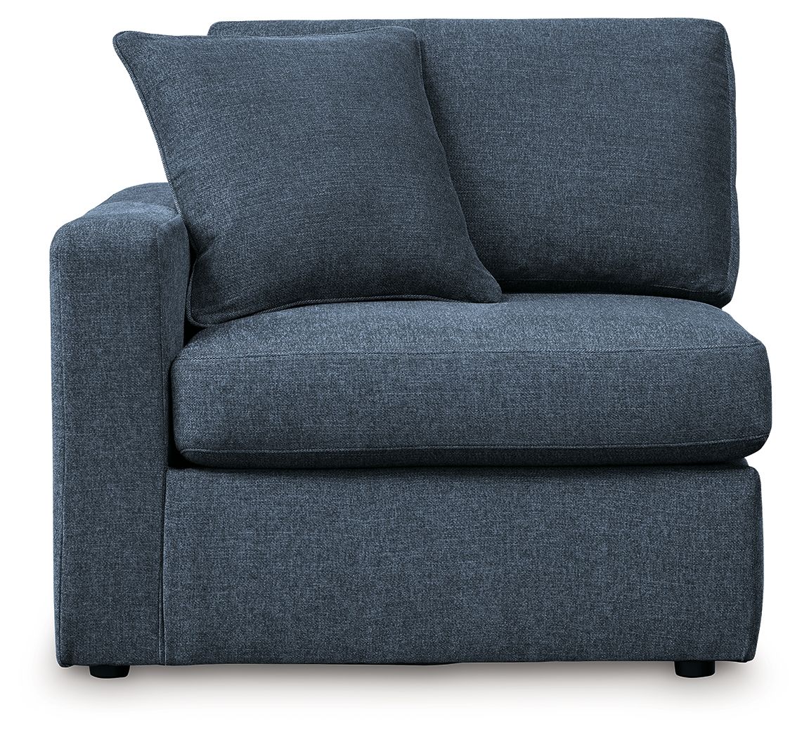 Dark blue upholstered armchair with padded seat, curved arms, and two back cushions