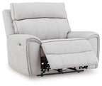Light gray power recliner chair with footrest extended and visible recline mechanism