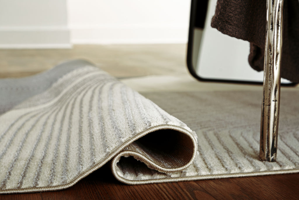 Winderburg rug edge rolled showing textured underside, wavy stripes