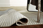 Winderburg rug edge rolled showing textured underside, wavy stripes