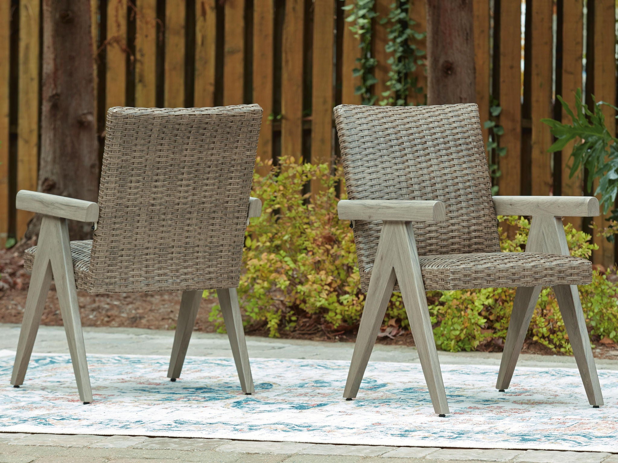 Beige outdoor arm chairs set of 2, woven seats with light wood armrests and angled legs