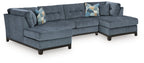 Sectional sofa with chaise in dark navy upholstery and geometric throw pillows