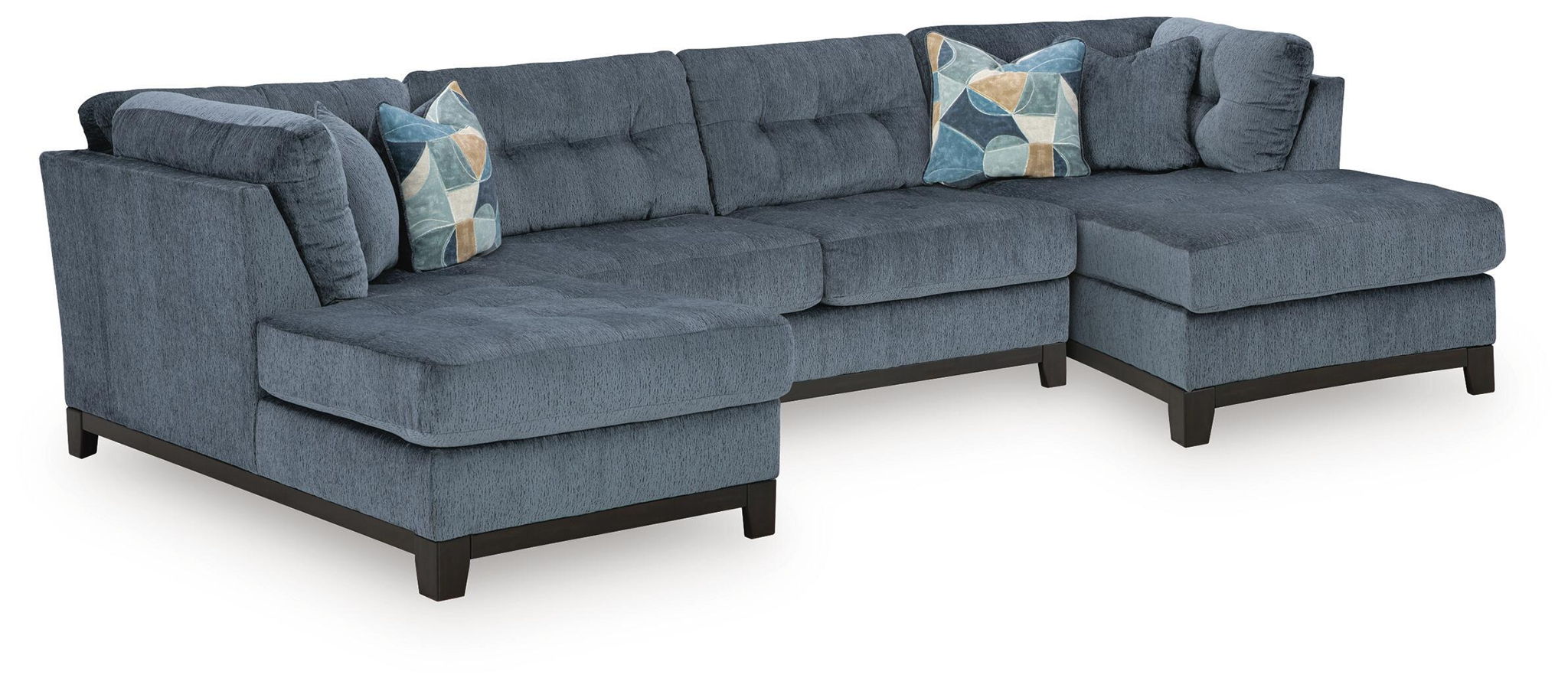 Sectional sofa with chaise in dark navy upholstery and geometric throw pillows