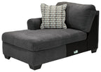 Slate LAF corner chaise in dark gray upholstery with tufted armrest and patterned throw pillow