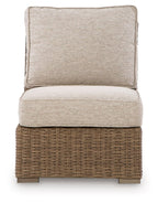 Beige armless chair with square back cushion and seat cushion, woven wicker base