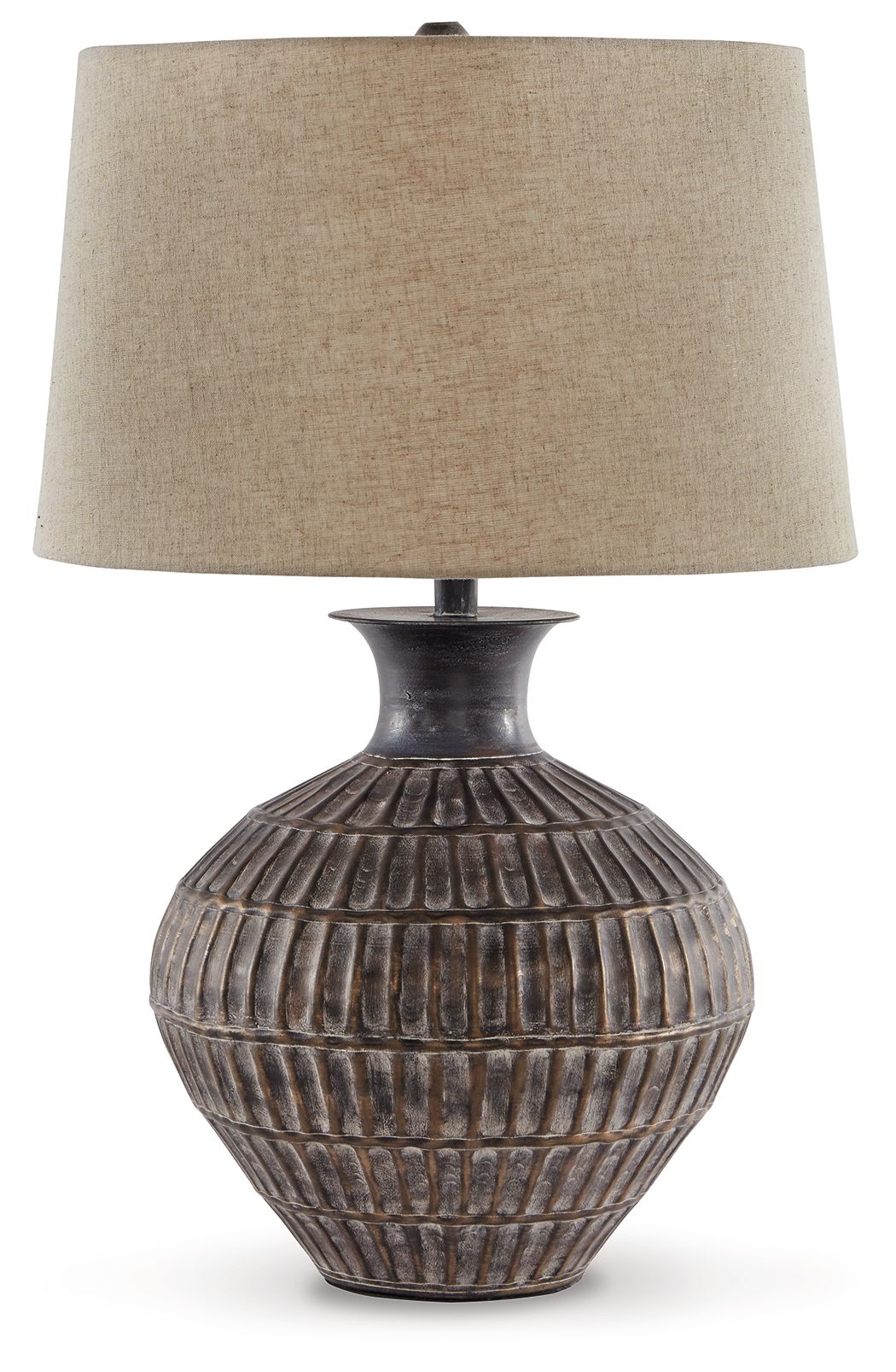 Antique bronze metal table lamp with textured urn base and beige fabric drum shade.
