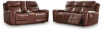 Dark brown power reclining sofa and loveseat with cushioned armrests