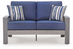 Blue upholstered loveseat with gray frame and two striped throw pillows, front view