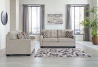 Light gray sofa set with matching loveseat and patterned throw pillows, dark feet