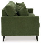 Green upholstered sofa with four throw pillows and dark tapered legs