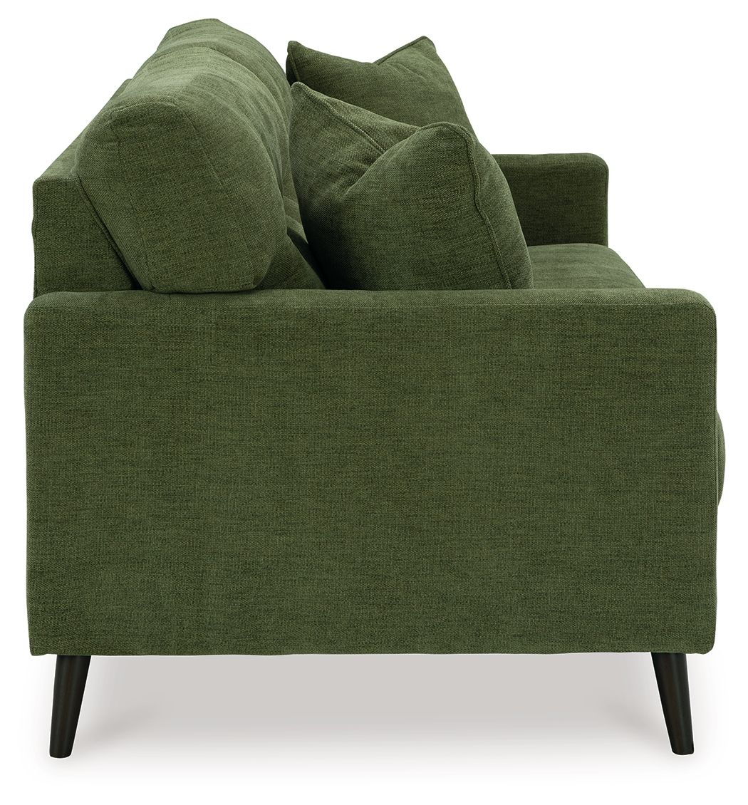 Green upholstered sofa with four throw pillows and dark tapered legs