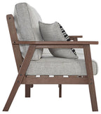 Grey upholstered sofa with brown wooden arms and black-and-white patterned pillow