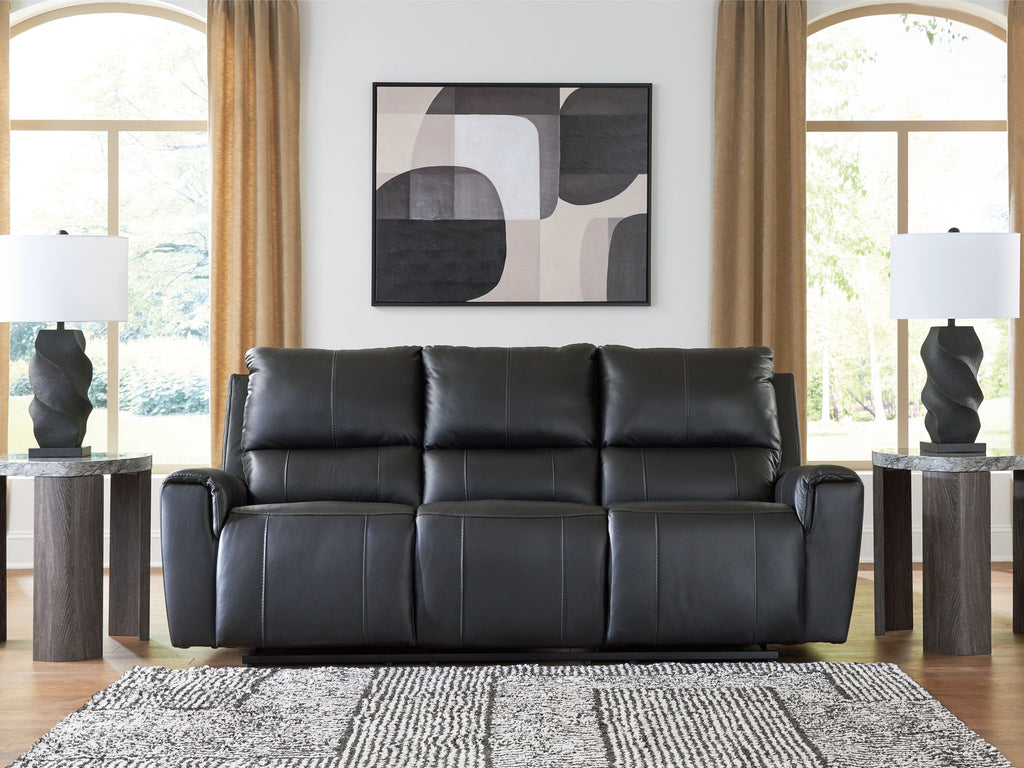 Black reclining sofa with tufted cushions and padded armrests