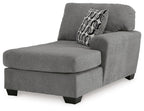 Gray corner chaise with rounded arm and patterned back cushion