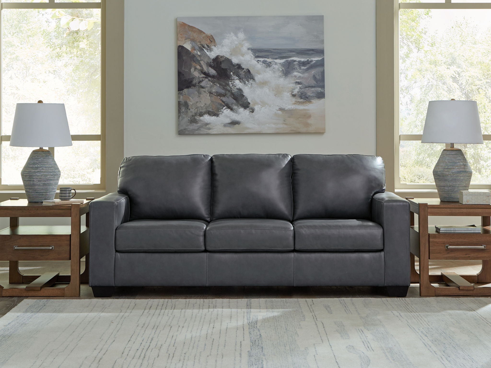Dark gray leather-look sofa with three seat cushions and three back sections