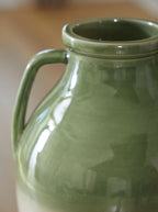 Green glazed vase close-up of neck rim and loop handle