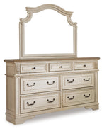 White dresser with mirror and six drawers, ornate trim and curved cabinet base.